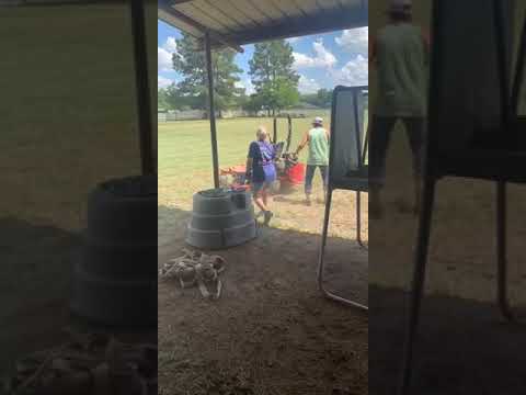 A Woman Tries To Stop An Out-Of-Control Lawn Mower…With A Stick