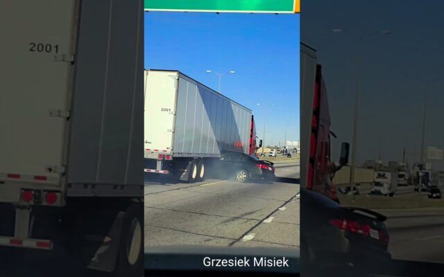 A Semi-Truck Dragging a Car Along a Highway as if Nothing’s Wrong